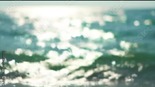 Beach bokeh background, soft focus sunlit ocean waves, warm golden sand, sparkling light reflections, dreamy summer atmosphere, pastel tones, shallow depth of field, natural and serene vibe