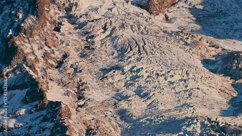 Mount Rainier glaciers, rugged, snow-covered slopes and ridges in dramatic winter light.