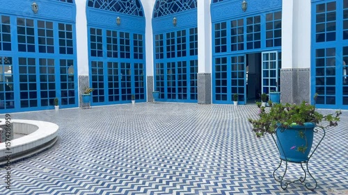 4K forward video shot of Mdiq near tangier blue mosque during sunny day in Morocco. Modern white and blue architecture of indoor facade and the fountain