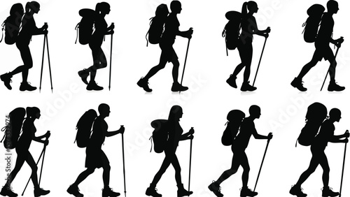 Diverse group of hikers with backpacks and trekking poles walking in silhouette