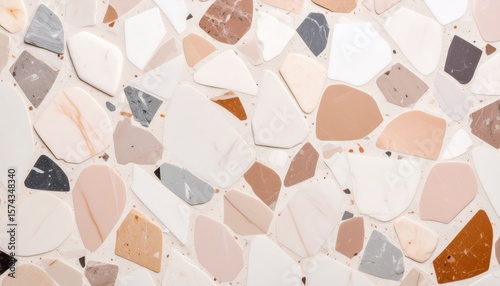 terrazzo surface pattern with scattered multicolored stone fragments on light background in decorative composite style
