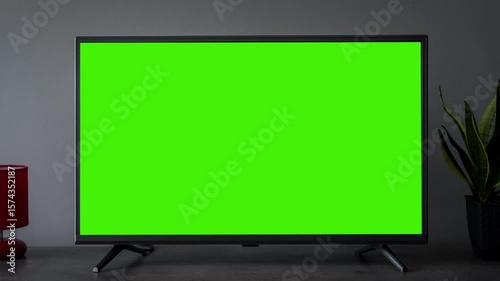 TV screen mockup background. Lcd tv monitor with blank green screen in living room while watching 