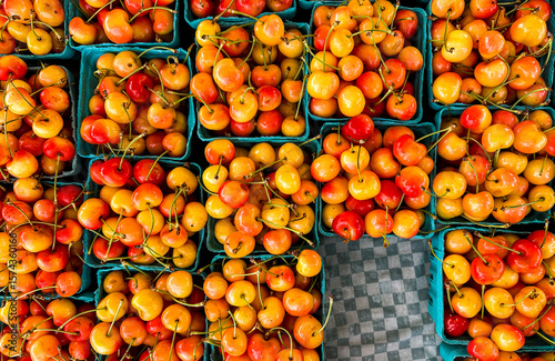 Freshly picked cherries displayed in baskets at a local farmers market in summer