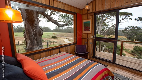 Cozy cabin bedroom with stunning rural vista and expansive window views of nature