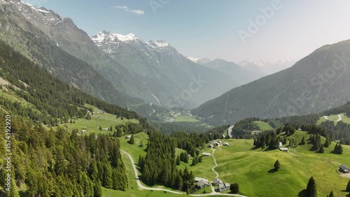 Scenic Aerial View of Green Forest and Hills Under a Cloudy Blue Sky