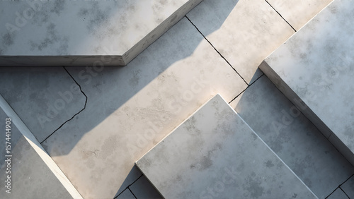 Top-down view of geometric concrete tiles, shadows creating minimal modern architectural rhythm and depth