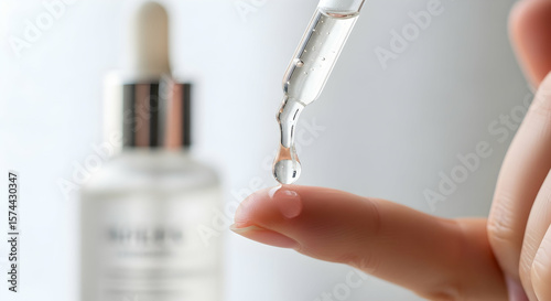 Applying skin serum to fingertip