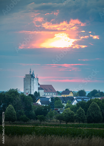 Modern industrial silos against a sunrise sky with architectural details