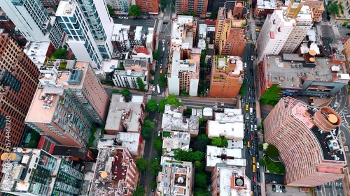 Busy roads among the blocks of modern metropolis. Drone footage over the roofs of New York, USA.