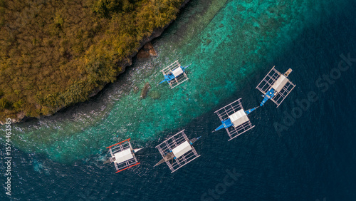 Fotografie Full Aerial Island View of sunny paradise Pescador Island Surrounded by Bangkas
