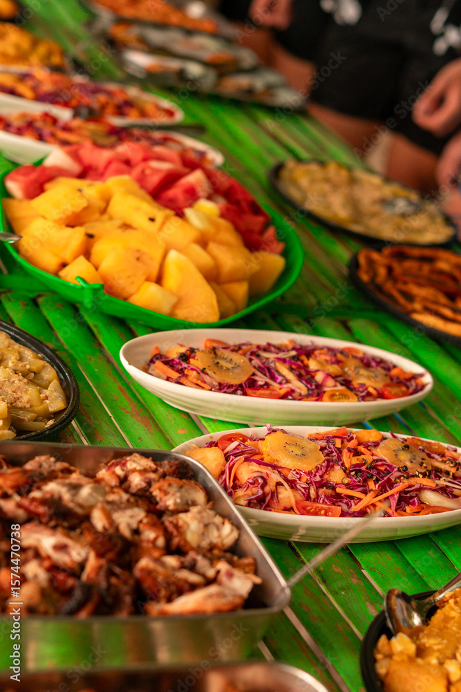 Fototapeta premium Filipino food buffet with pork and fish, seafood, noodles and vegetables for tour tourist in El Nido, Palawan, Philippines 