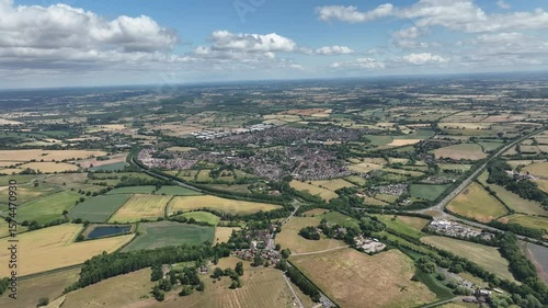 Scenic View of Small Town Surrounded by Lush Farmland and Trees