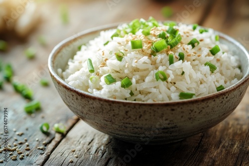 Delicious closeup of steamed white rice bowl with green onions kitchen table food photography rustic environment top-down view culinary delight