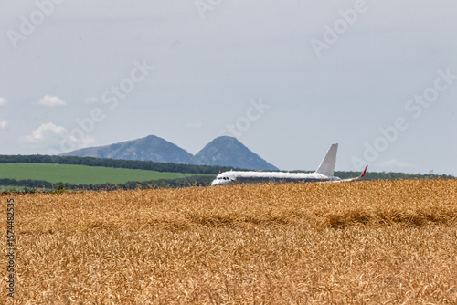 A passenger plane takes off on a very hot summer day