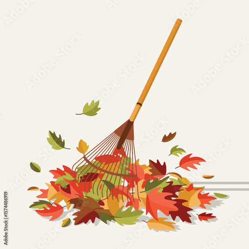 Autumn leaf raking with a garden rake and colorful fallen leaves