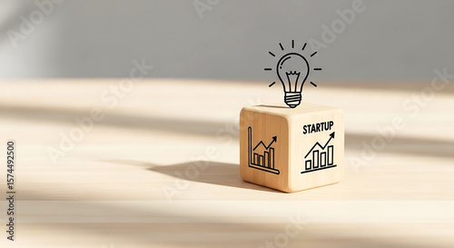 Wooden block with light bulb and growth icons representing innovation strategy and business success
