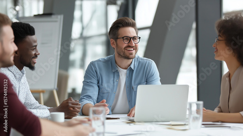 Group of business people in an office sitting around a table, discussing ideas. A man holds a pen and points at a blank whiteboard, promoting teamwork, planning, and strategy