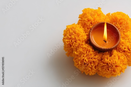 Festive diya lamp glows warmly on marigold flowers during Diwali festival, symbolising light overcoming darkness and good prevailing