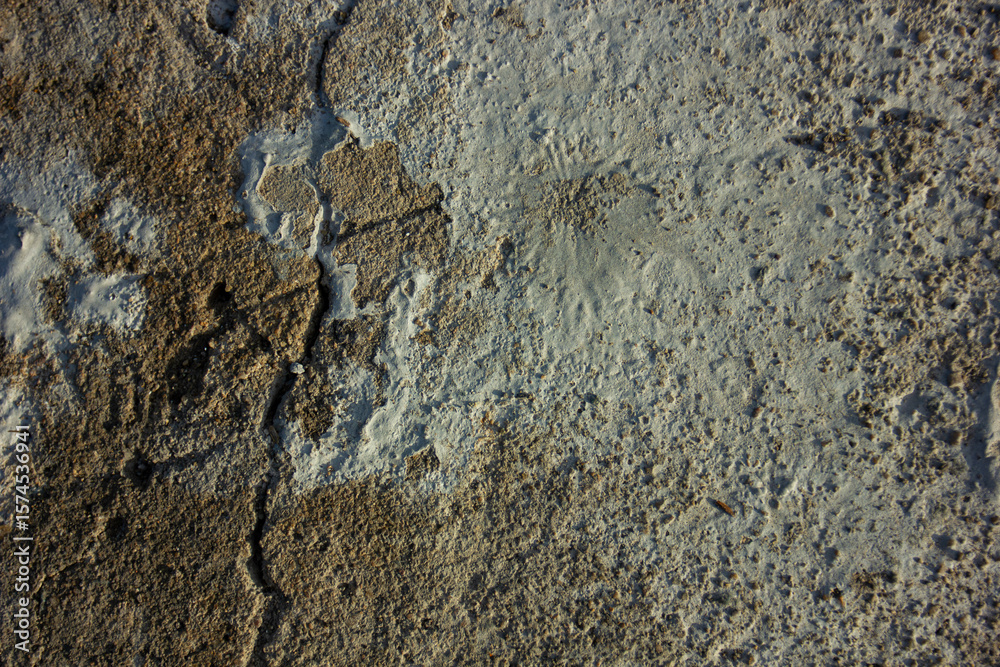 Naklejka premium Abstract texture of an old, cracked concrete wall with two contrasting colors. A gritty background for themes of contrast, old and new, or repair