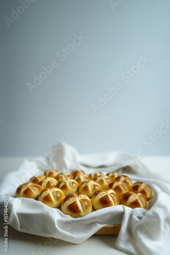 Celebrating Swiss National Holiday. Homemade buns called 1 August-Wegge in German are in the bread basket with grey background.