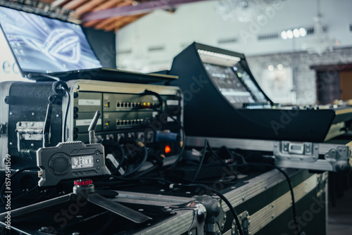 Equipment ready for audio and video transmission at a live event. Wireless video transmitter, connection rack, laptop, and audio mixer.
