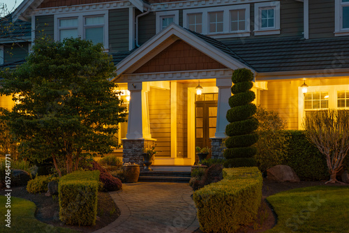 Entrance of luxury house with nice spring blossom landscape at night in Vancouver, Canada, North America. May 2025.