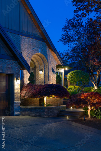 Entrance of luxury house with nice spring blossom landscape at night in Vancouver, Canada, North America. May 2025.