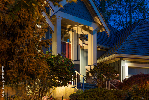 Entrance of luxury house with nice spring blossom landscape at night in Vancouver, Canada, North America. May 2025.