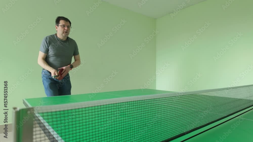 Player performing spin serve with red paddle during table tennis game action
