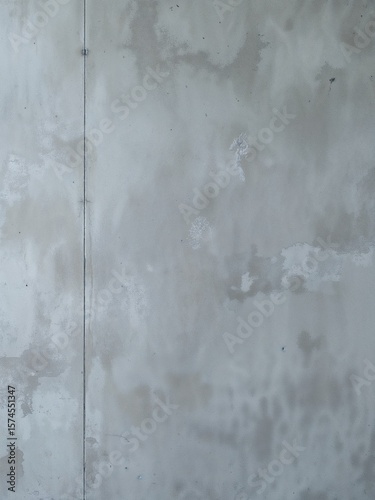 A simple gray wall with a vertical line running along the left side of the frame and some imperfections
