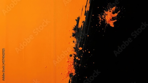 Abstract contrasting background with a vibrant orange section meeting a textured black area with scattered powder