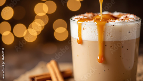 Delicious caramel latte with cinnamon sticks and warm bokeh background  