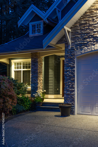 Entrance of luxury house with nice spring blossom landscape at night in Vancouver, Canada, North America. May 2025.