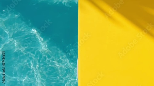 Turquoise water meets yellow surface with shadow
