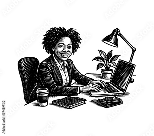 Smiling African American woman in suit working on laptop at desk with lamp and plant