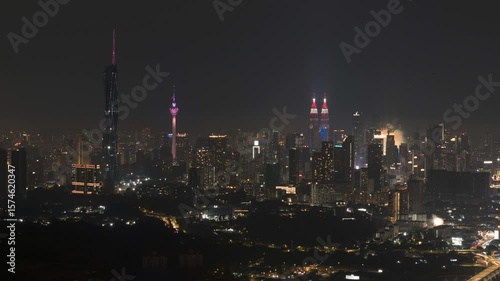 Aerial view of night scene at Kuala Lumpur with fireworks show. Zoom out