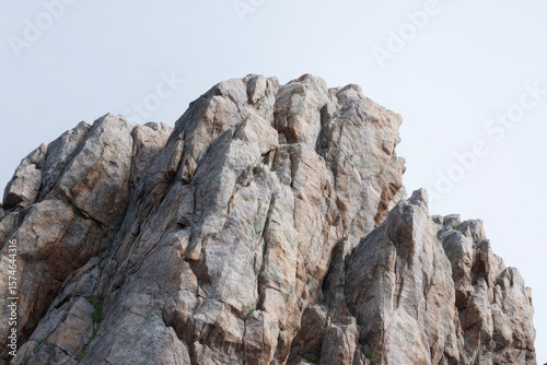 Jagged rock formation atop mountain under clear sky