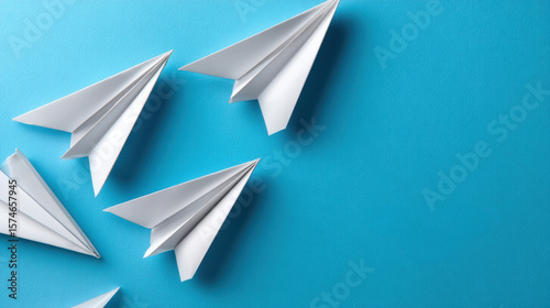 Hopeful paper plane flying on blue background. Leadership and teamwork concept showing direction and ambition