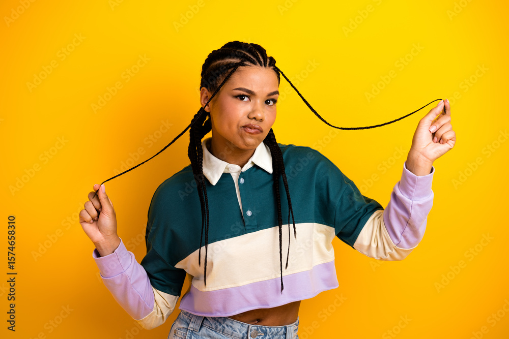 Fototapeta premium Trendy casual young woman with stylish braids in a vibrant background expressing creativity and style