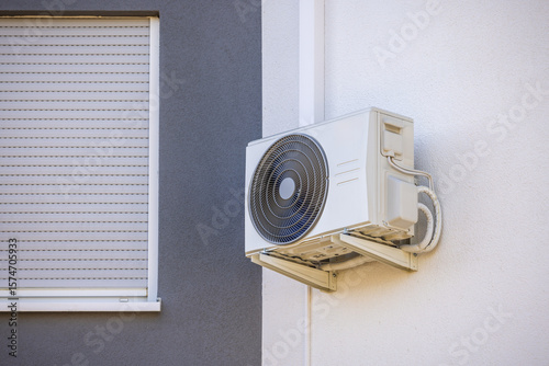 Obraz na płótnie Air conditioner and heat pump installed on a wall of family house, split system