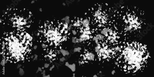White snowflakes on a black background surface. Macro nature pattern backdrop. Snow overlay background isolated on black. Winter concept. scratches and cracks which can be used as a background.