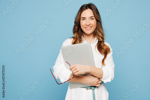 Young smart employee IT business woman corporate lawyer in shirt classic formal clothes work in office hold glasses closed laptop pc computer isolated on pastel light blue background studio portrait