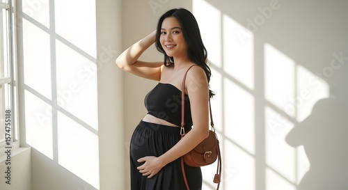 A radiant pregnant woman, glowing in soft sunlight, gently cradles her belly. She exudes joy and serenity, a beautiful moment of expectant motherhood. Free Download A radiant pregnant woman, glowing in soft sunlight, gently cradles her belly. She exudes joy and serenity, a beautiful moment of expectant motherhood. - GFXLoad