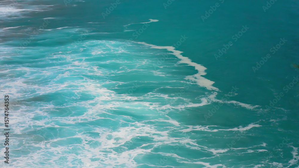 Obraz premium Ocean surface with turquoise water and white foam, creating a dynamic and visually appealing seascape.
