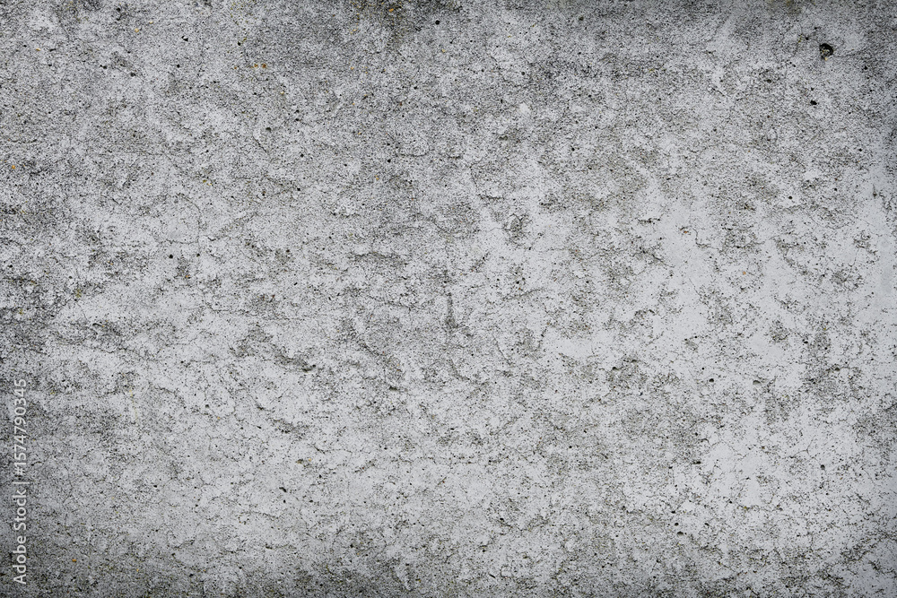 Obraz premium Cracked concrete wall covered with gray cement surface. Grey old wall with shabby damaged plaster or cement and brick background of an vintage dirty exfoliating plaster. Mock up.