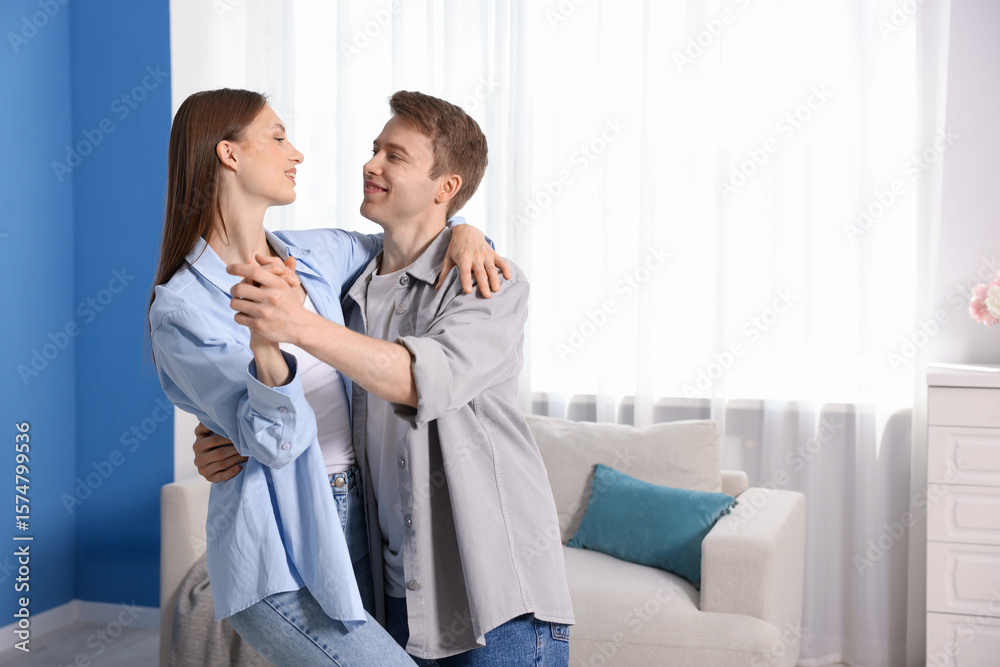 Obraz premium Happy couple dancing at home. Space for text