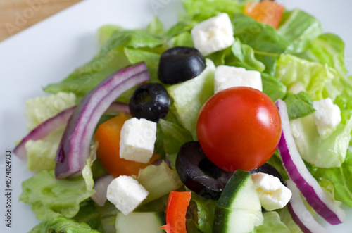 Closeup Details of Fresh Greek Salad on a White Plate