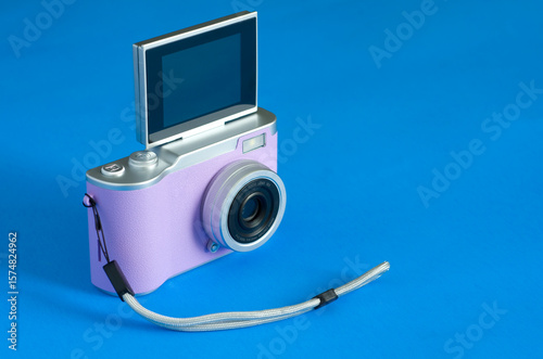 Cheap Pink Digital Camera on Blue Background