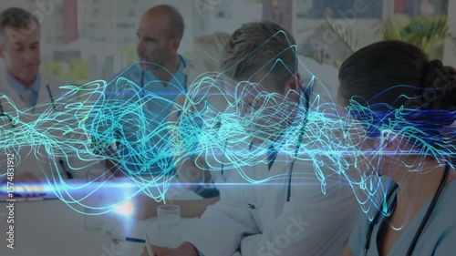 Medical team writing notes, tapping tablet collaborating under blue waveform overlay appearing