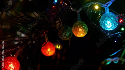 Glowing Christmas lights gently blinking in rhythm along animated strings across a dark background

